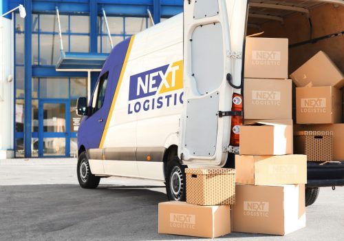 Branded bus fully loaded of packages with nextlogistic logo on them