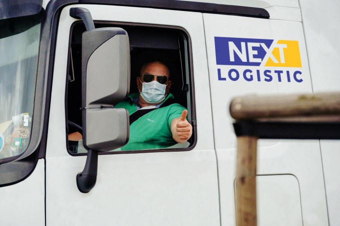 truck driver with a protective mask showing a thumb up