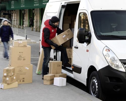 Loading packages in a van on a city street